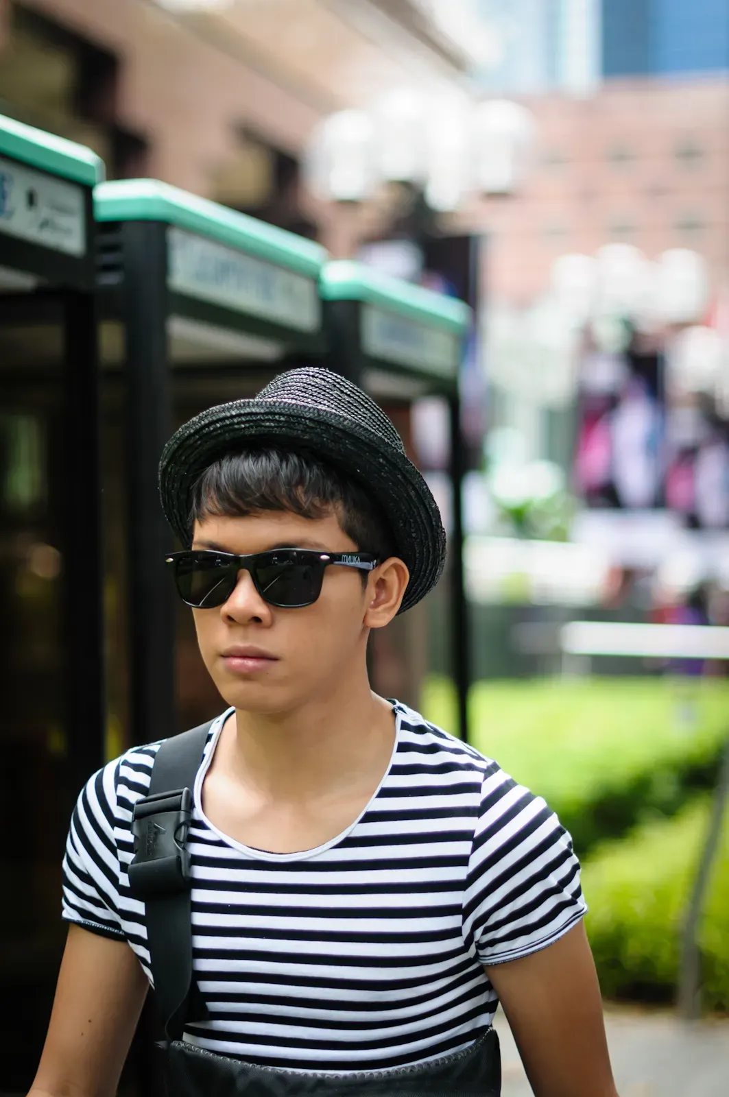 man with a hat wearing shades and stripes