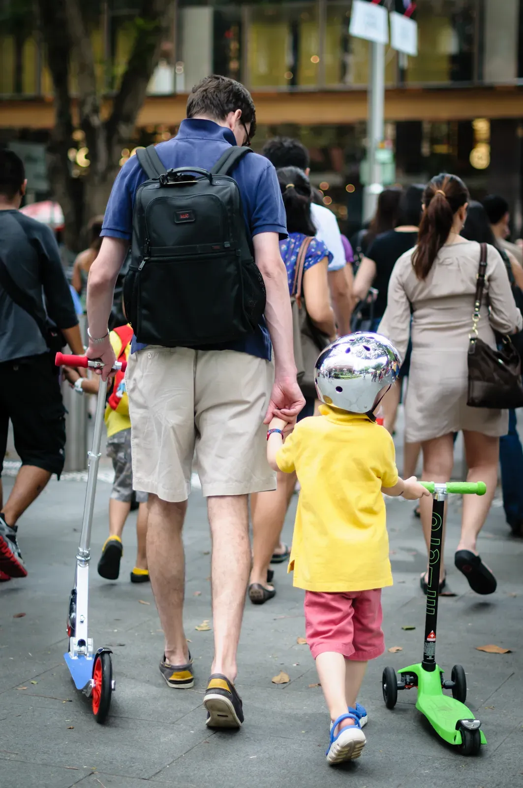 father and son with their scooters