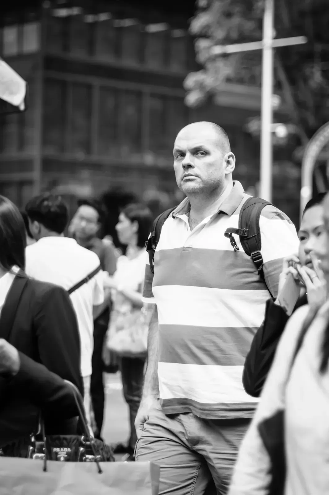 man in broad-striped polo t-shirt looking at the camera