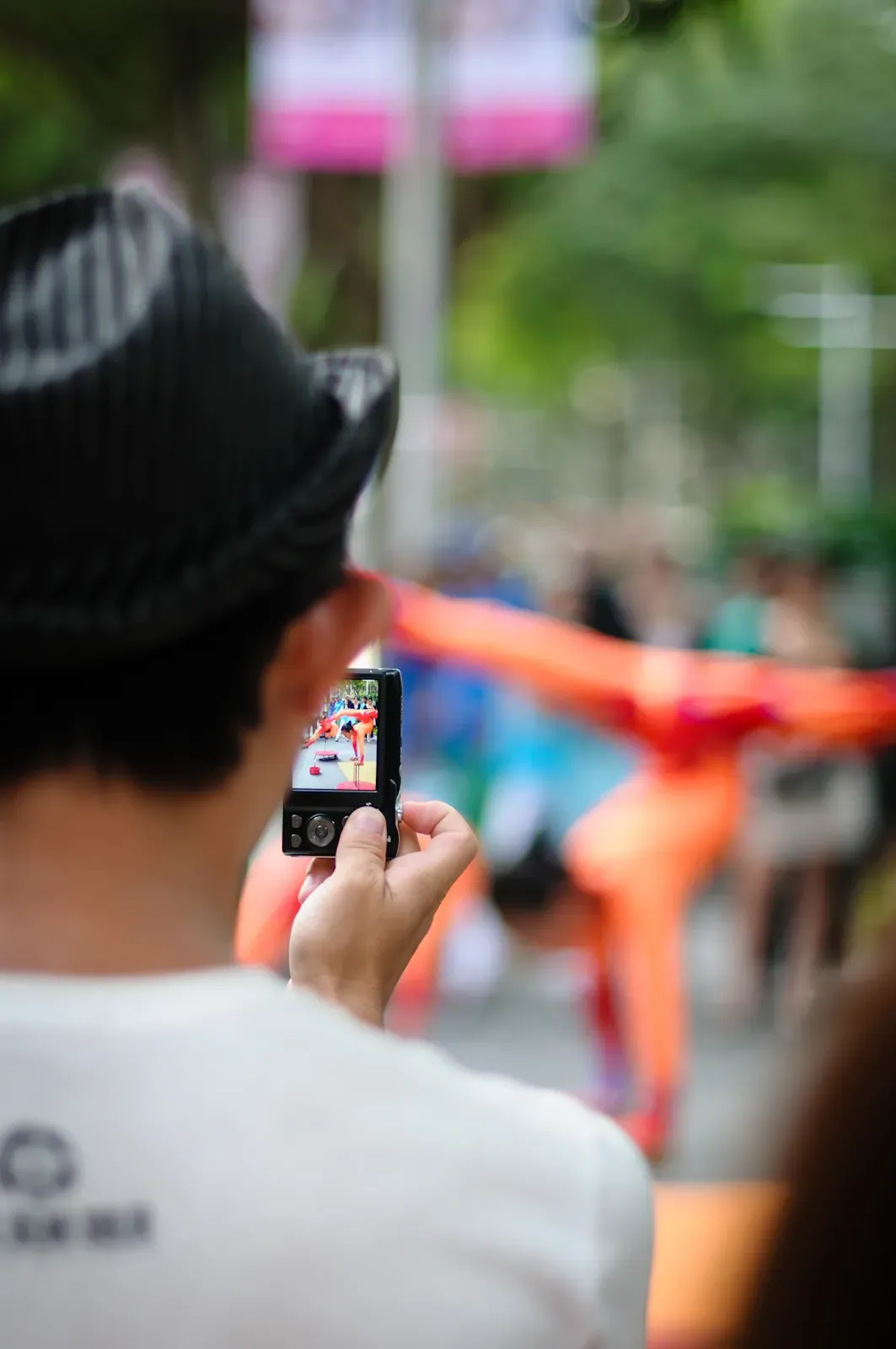 Man taking a photo of a street performer