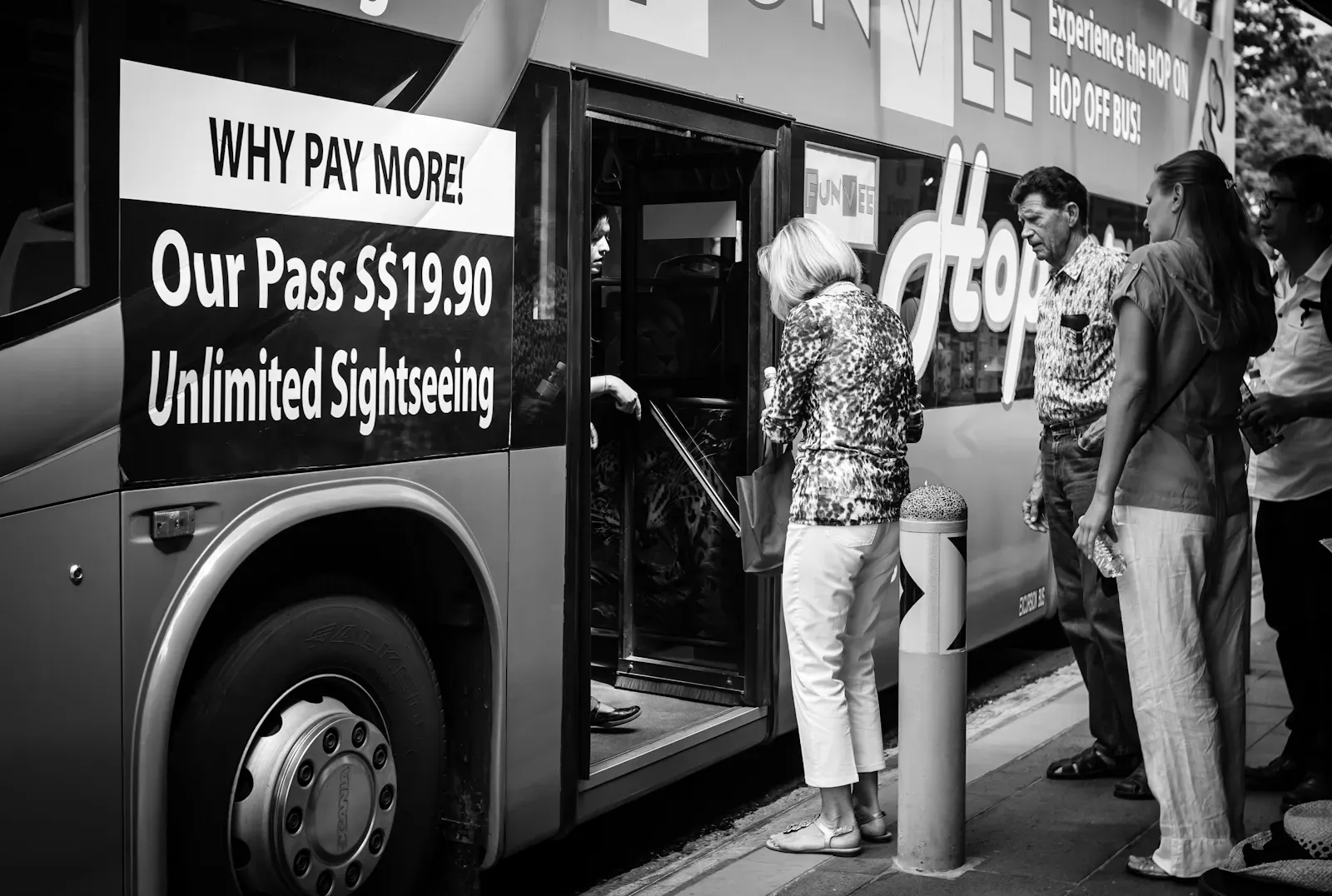 tourists boarding a sightseeing bus