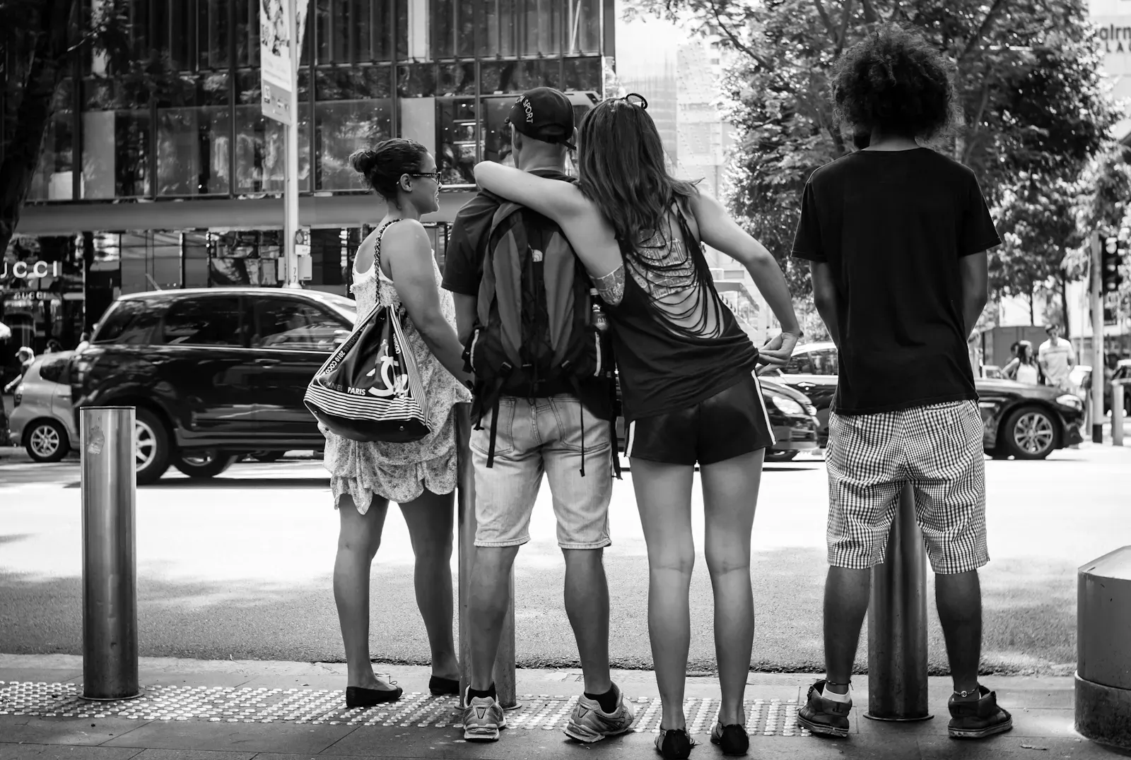 four friends waiting to cross the road