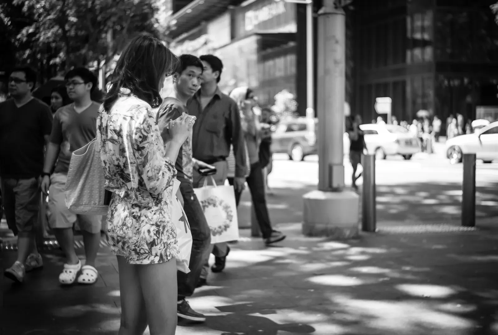 girl in floral clothing standing in the middle of the side walk