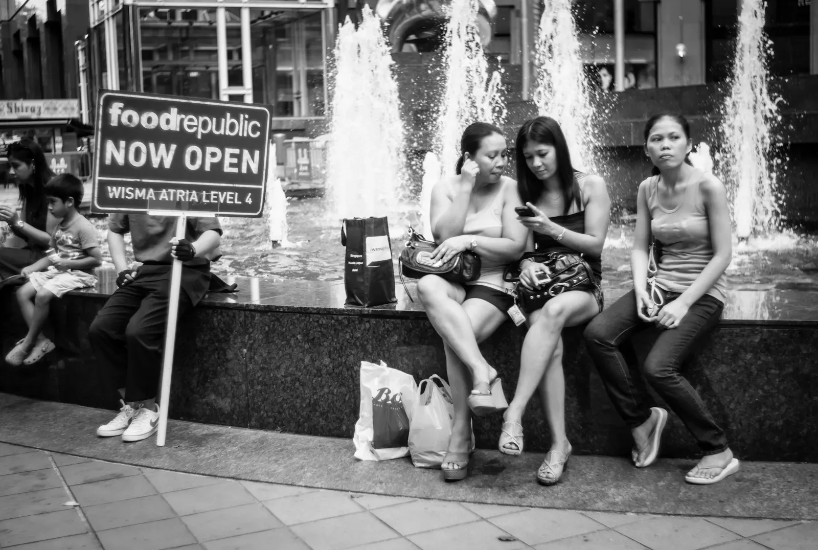 People resting at the Ngee Ann City fountain