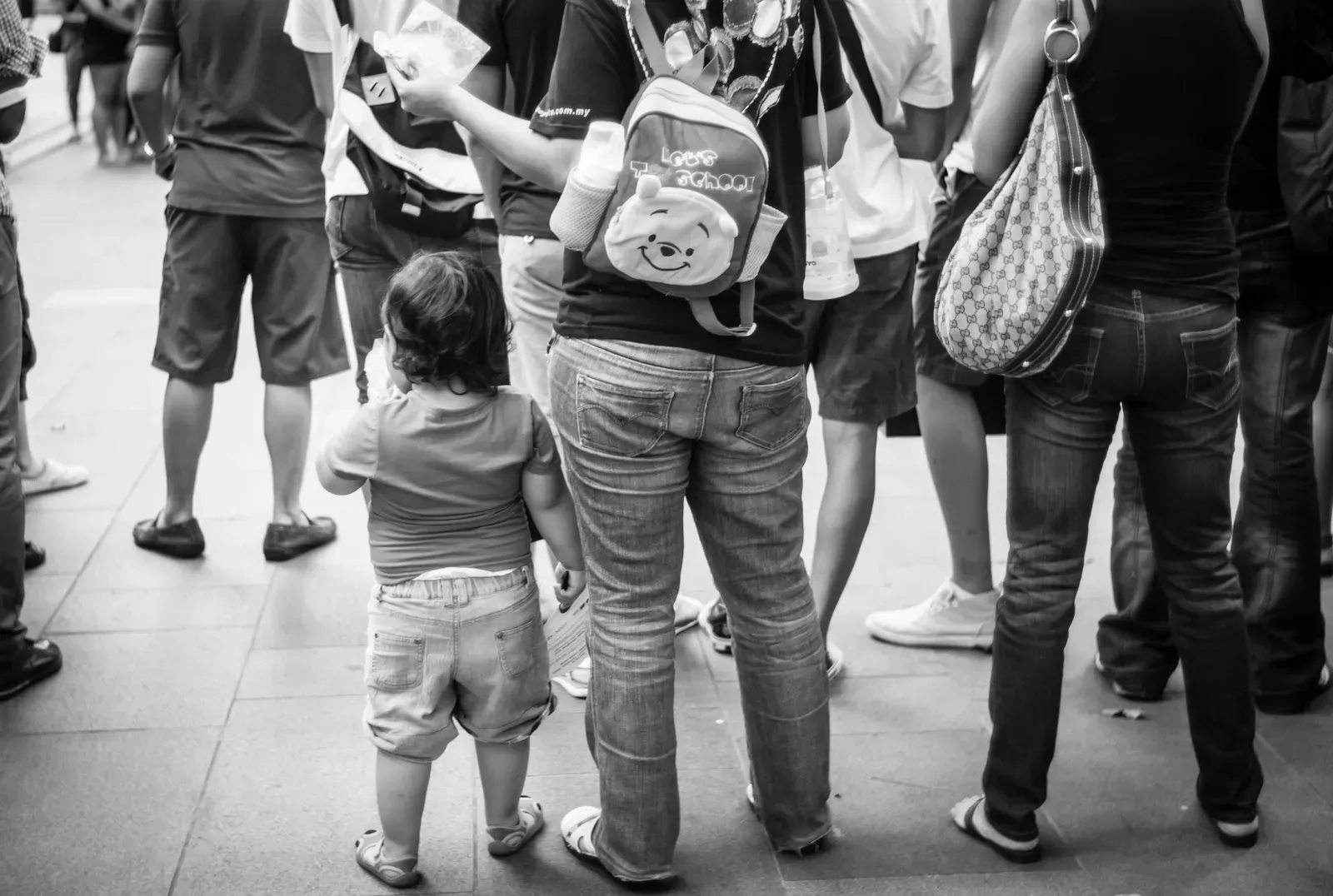 Mother carrying Winnie the Pooh bag