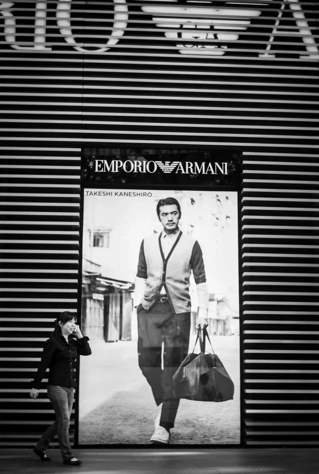 Woman walking in front of Emporio Armani