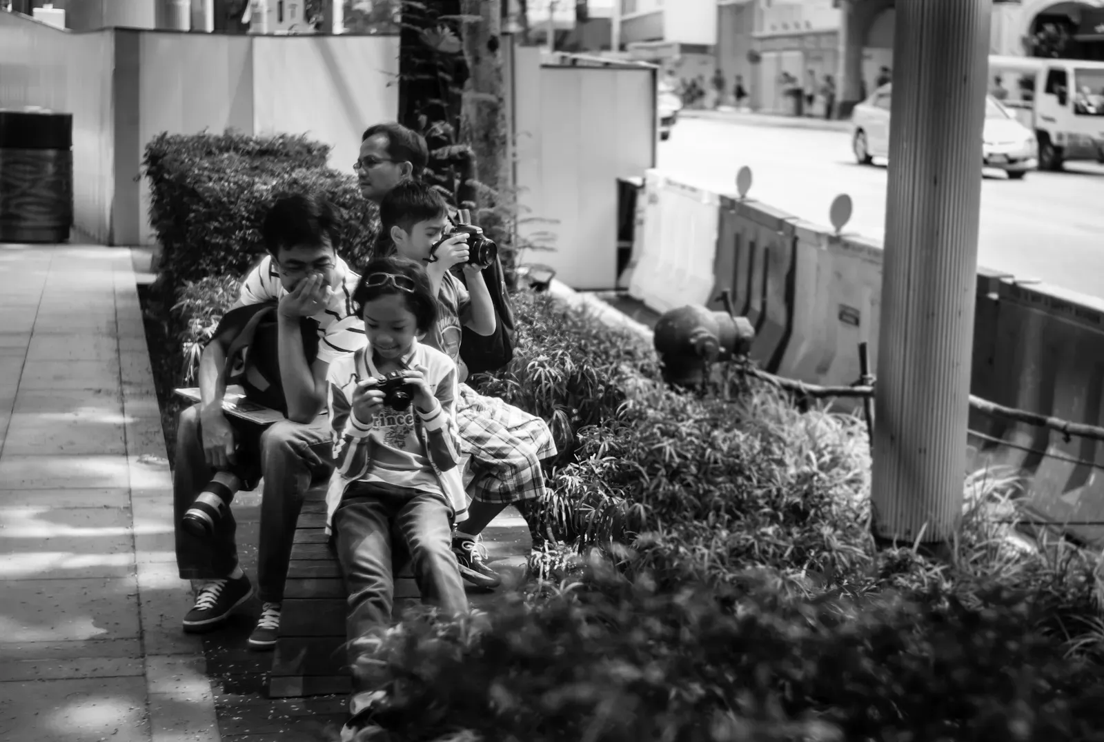 Father, son and daughter each holding their own cameras