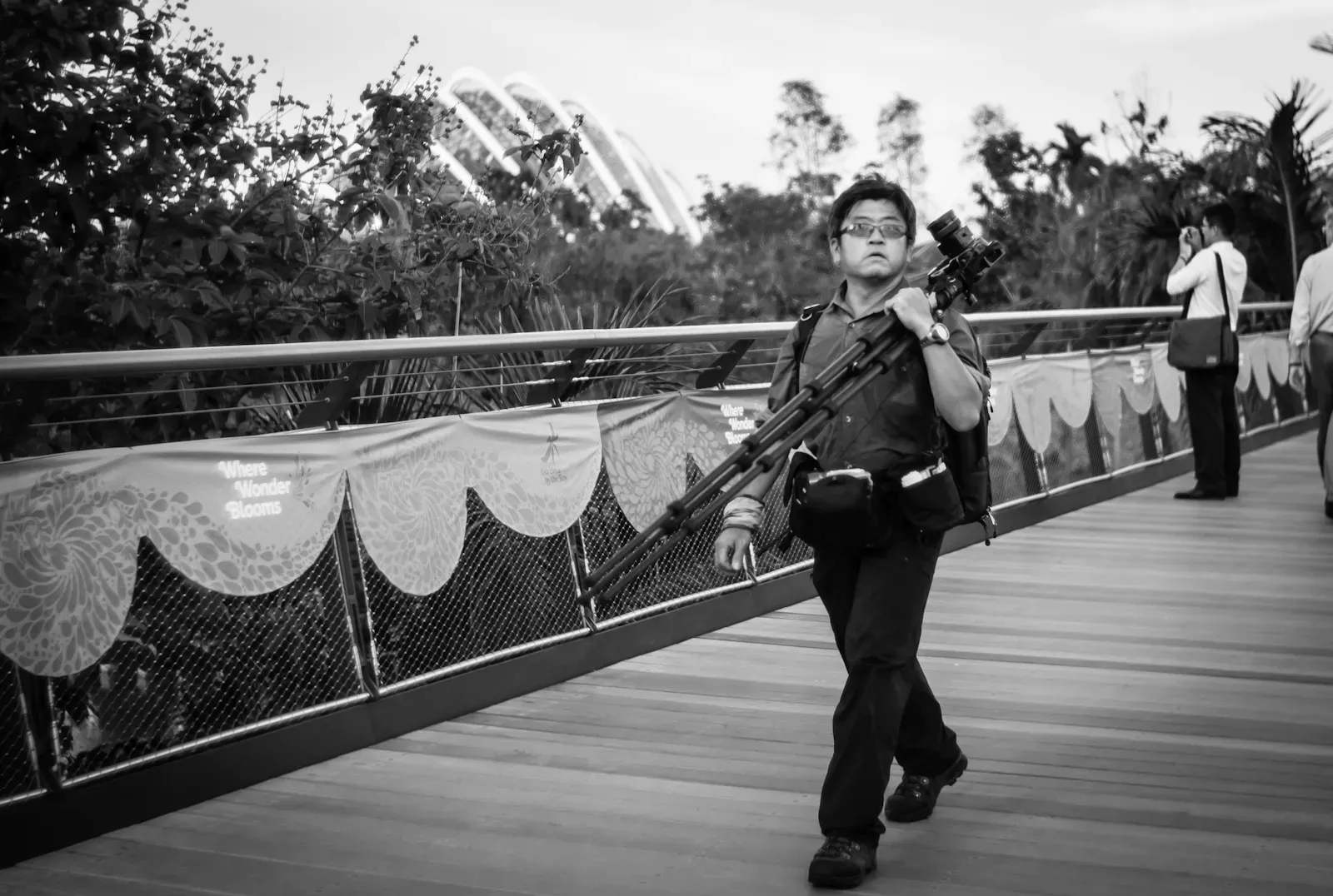 Photographer walking on a bridge