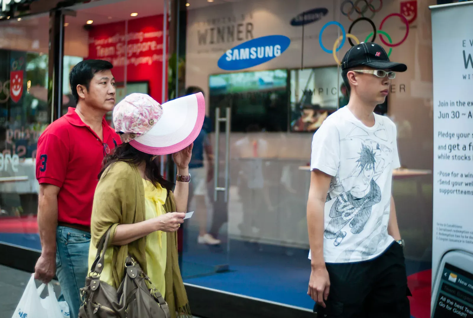 Woman with a large cap and man with a small cap