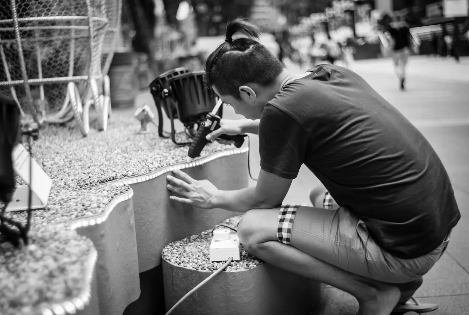 A man setting up decorations along Orchard Road