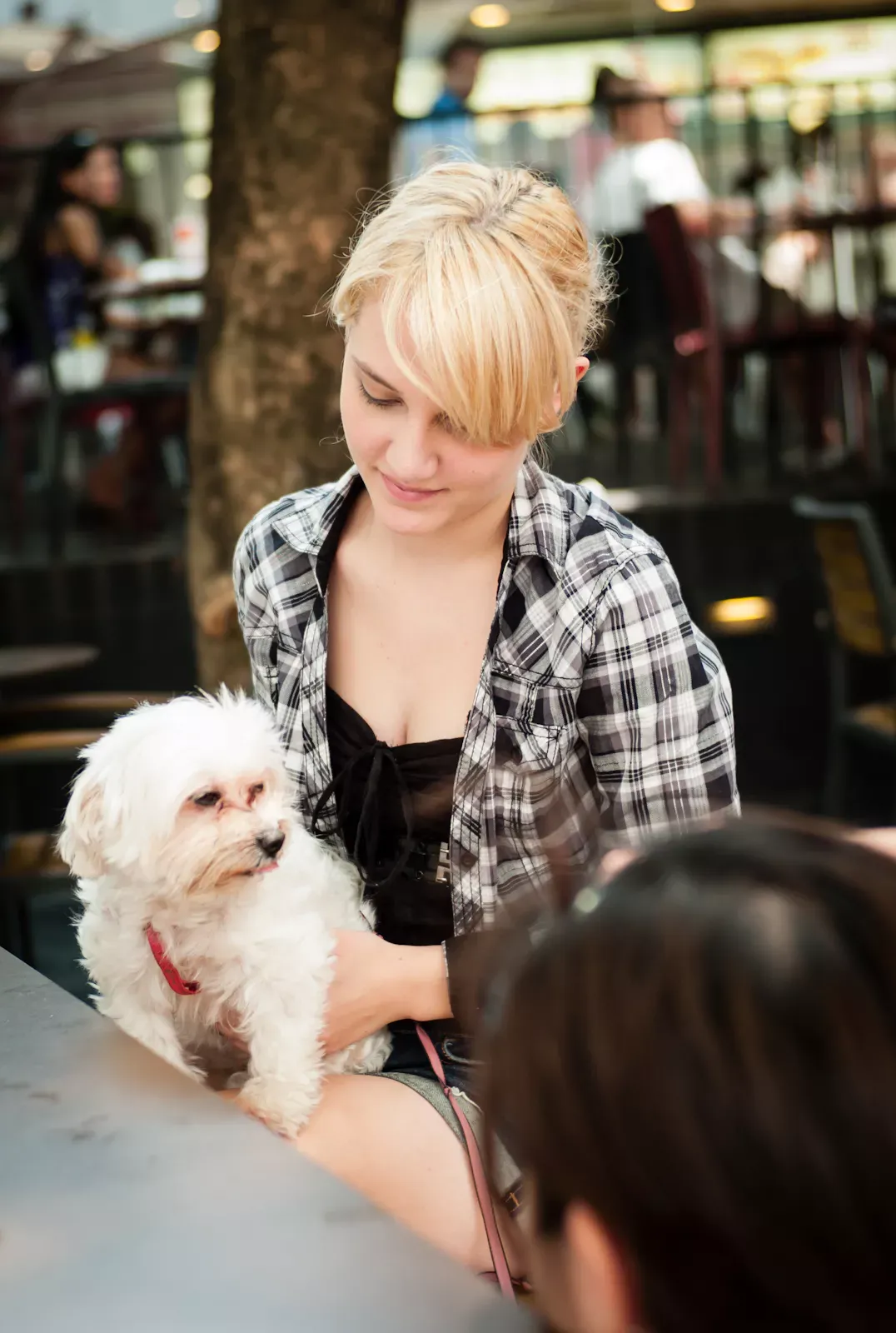 A woman carrying her pet dog