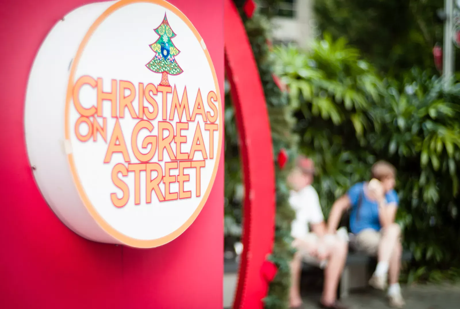 Tourists resting along Orchard Road