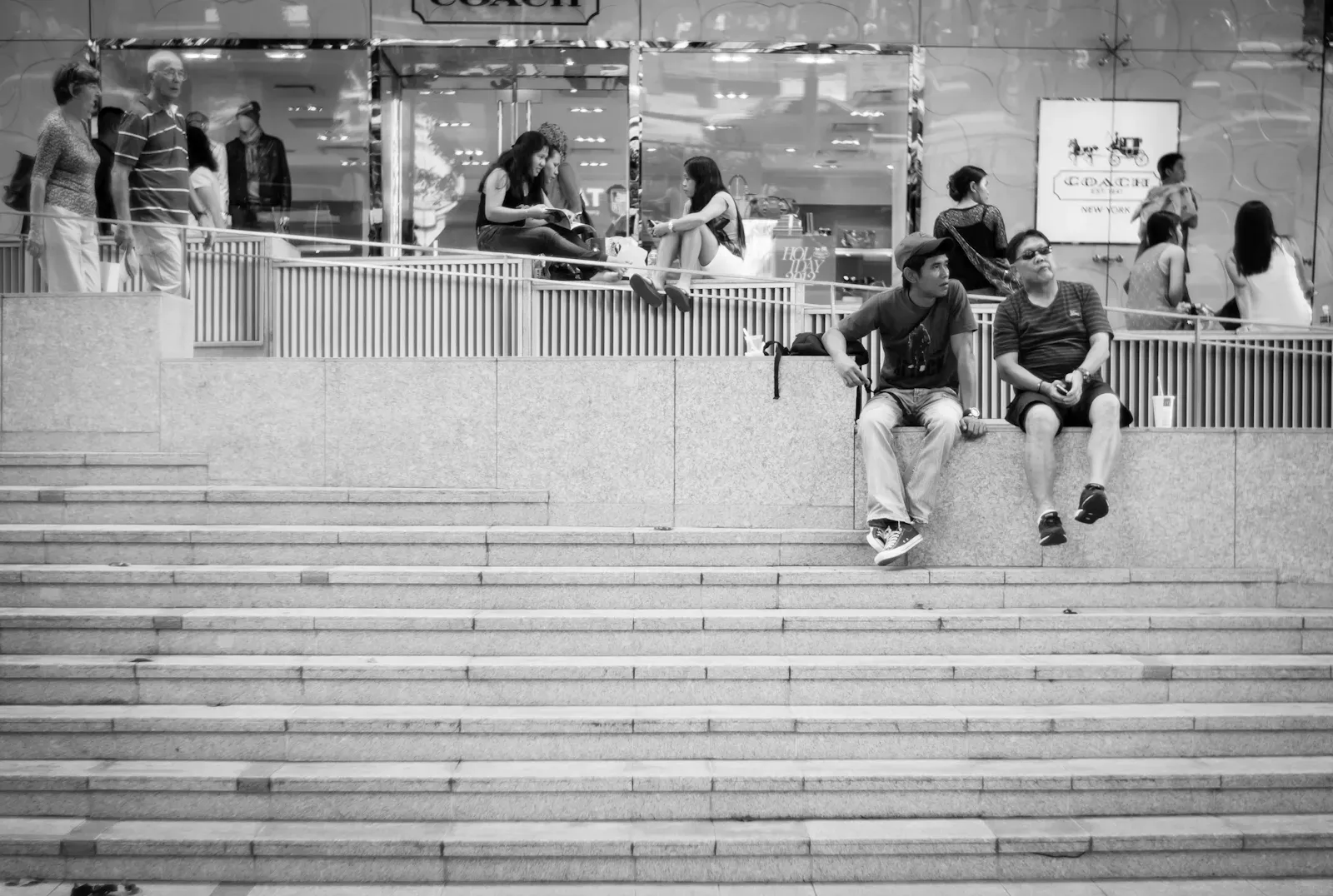 Tourists sitting along Orchard Road