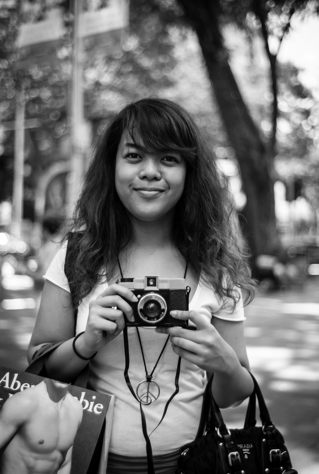 Street photography - girl shooting with a Diana F in Orchard Road
